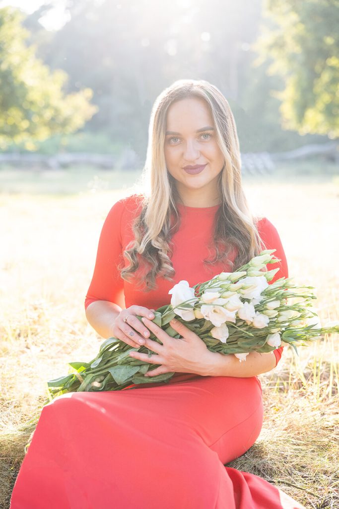 Sommershooting Köln – Frau im roten Kleid mit weißem Blumenstrauß im Sonnenlicht