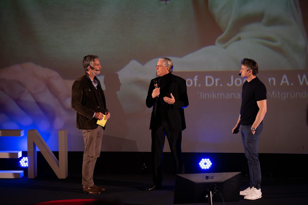Drei Redner im Gespräch auf der Bühne bei TEDxEssen